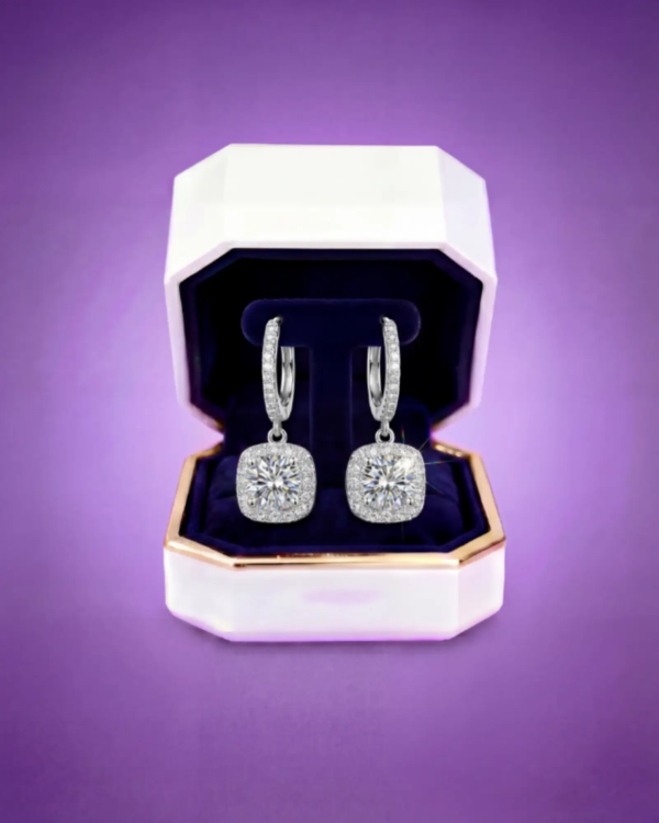 Moissanite drop earrings showcased in a premium jewelry box with deep velvet interior.