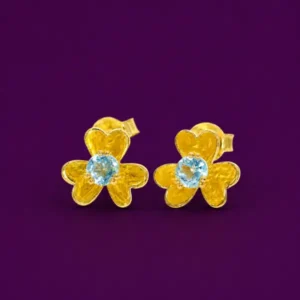 Blue topaz stud earrings in 18k gold vermeil over silver, flower-shaped setting