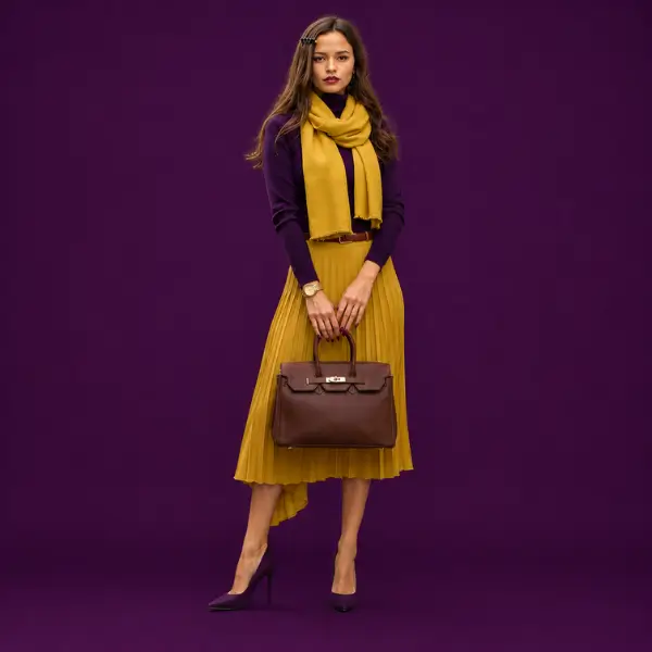 Maria wearing luxury gifts for her: leather handbag, gold watch, scarf and hair barrette