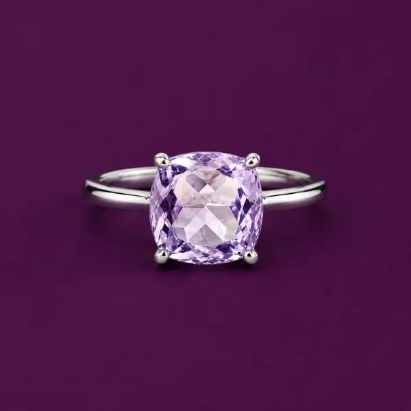 Amethyst solitaire ring in gold setting, Brazilian amethyst on plum background