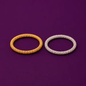 Silver and gold vermeil stackable rings jewelry presented side by side on plum background