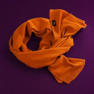 Orange cashmere scarf folded elegantly, part of the Art of Giving gift collection