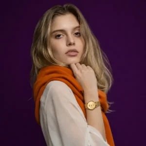 Corina wearing a cashmere scarf for women in a soft orange tone