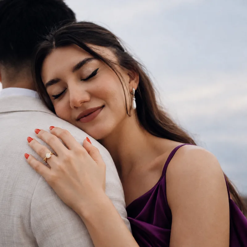 Claudia wearing a diamond engagement ring by Maison Tasia